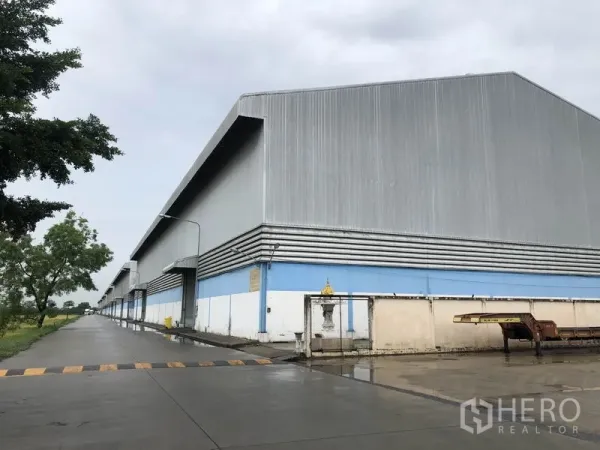 Warehouse for rent in Phra Nakhon Si Ayutthaya - Metal-clad warehouse exterior with long driveway and loading bays in Bang Pa-in, Ayutthaya.