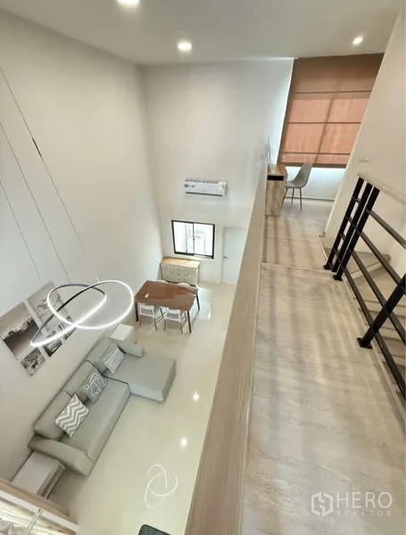 Townhouse for rent in Bang Phli, Samut Prakan - View from the mezzanine overlooking the double-height living area and study nook.