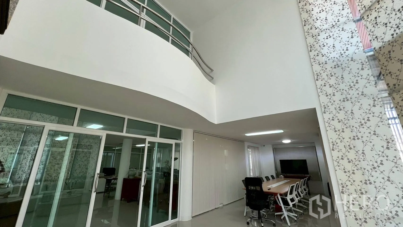 Home Office for rent in Wang Thonglang, Bangkok - Double-height atrium with mezzanine railing above a glass-walled boardroom.