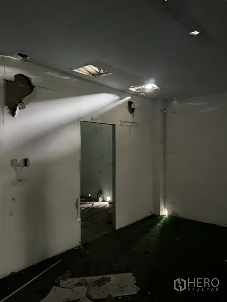 Warehouse for rent in Bang Kapi, Bangkok - Small interior room with open doorway and broken ceiling panels inside the warehouse.