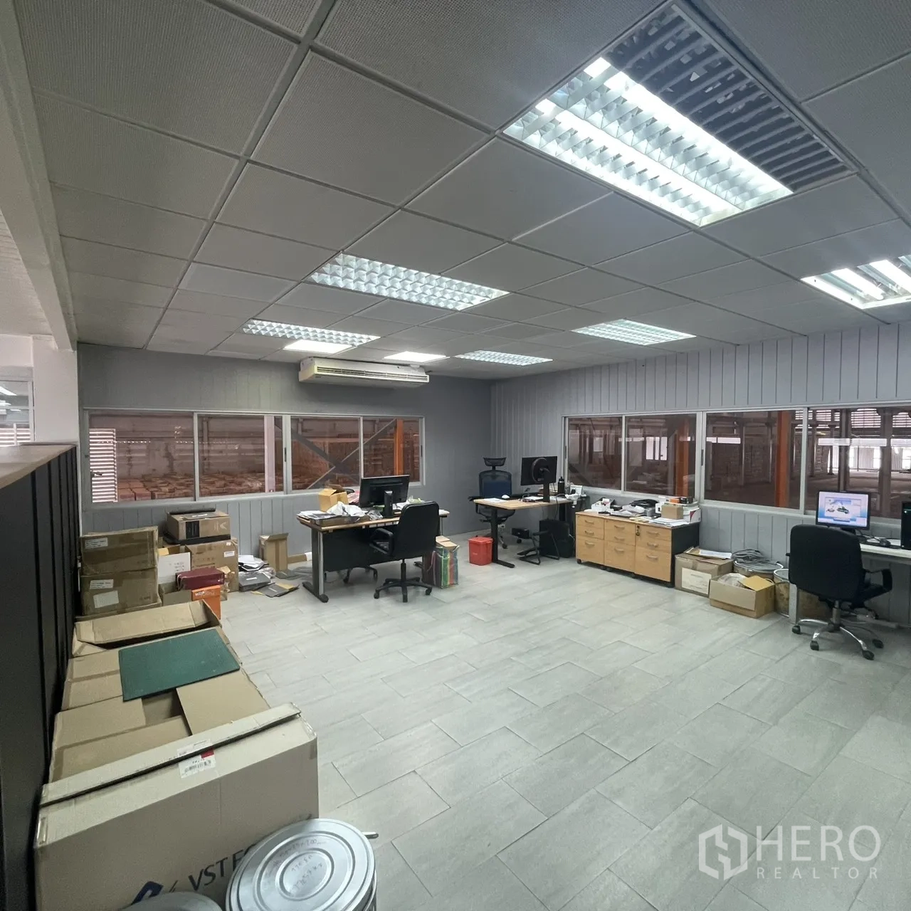 Factory for rent in Khlong Toei, Bangkok - Secondary office room with multiple desks, filing cabinets, and tiled flooring.