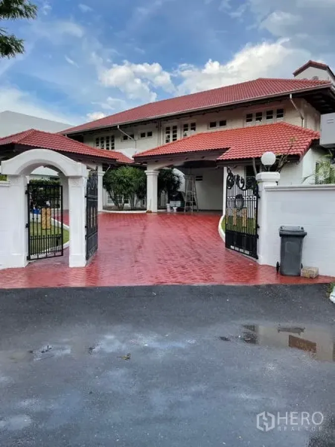 Detached House for rent in Bang Phli, Samut Prakan - Gated entrance with a red brick driveway, white fence, and covered carport.