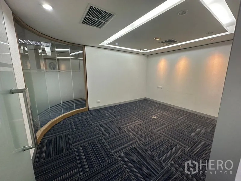 Office Space for rent in Khlong Toei, Bangkok - Small meeting room with curved glass wall and recessed ceiling lights.