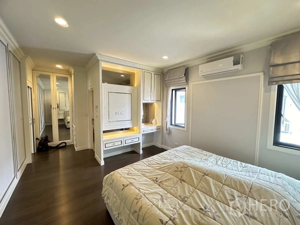 Detached House for rent or sale in Lam Luk Ka, Pathum Thani - Cozy bedroom with built-in desk, cabinets and air conditioner.