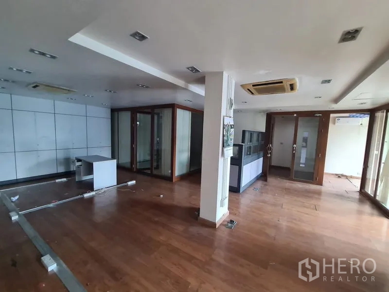 Office Space for rent in Bang Rak, Bangkok - Large office area with wood floors and cassette air conditioners.