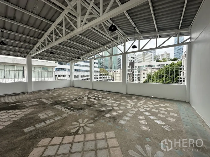 Retail Space for rent in Bang Rak, Bangkok - Spacious covered rooftop area with steel roof and patterned floor.