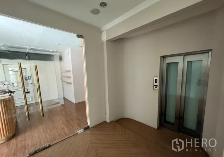Retail Space for rent - Lift lobby with glass entry to the retail unit and herringbone wood floor.