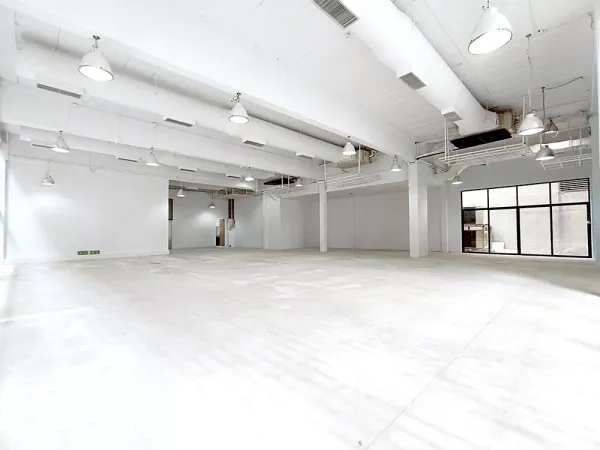 Office Space for rent in Watthana, Bangkok - White industrial-style ceiling with multiple pendant lights over a large open workspace.