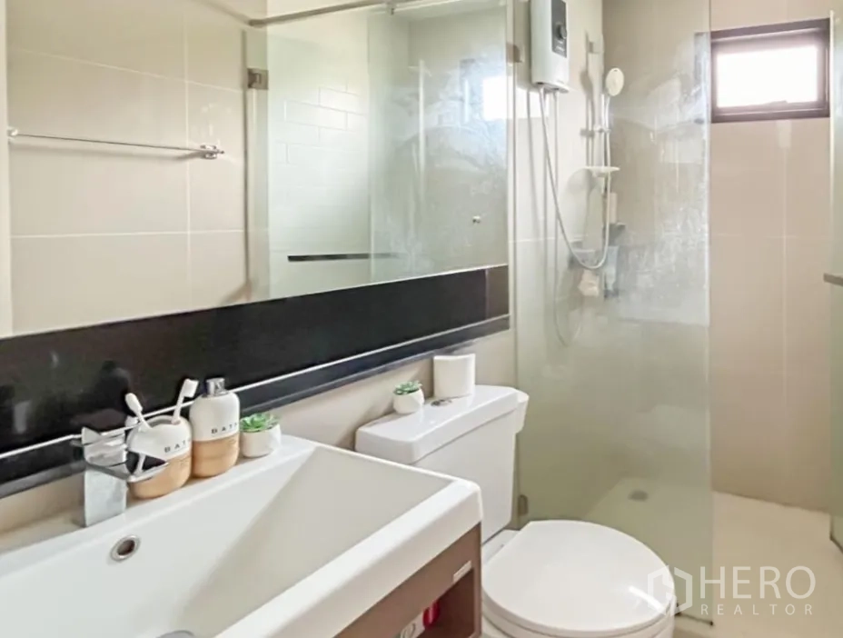 Detached House for sale in Lam Luk Ka, Pathum Thani - Shared upstairs bathroom with vanity and glass shower enclosure.