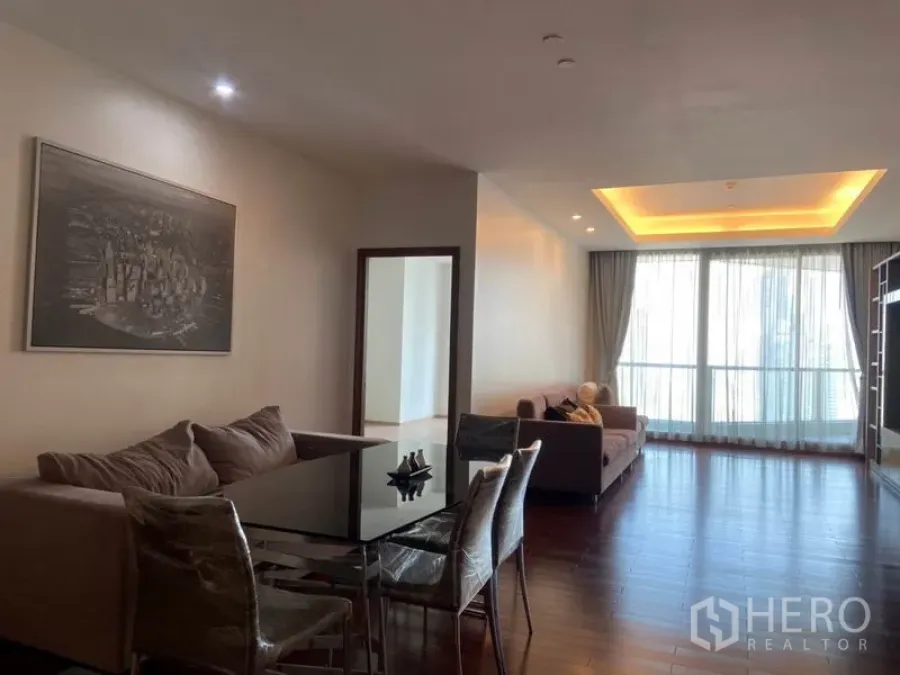 Condominium for rent in Sathon, Bangkok - Spacious living and dining room with recessed ceiling lights, hardwood floors, and floor‑to‑ceiling windows.