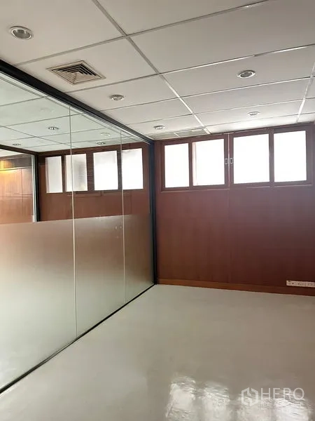 Office Space for rent in Pathum Wan, Bangkok - Private office with frosted glass partition, drop ceiling and high windows.