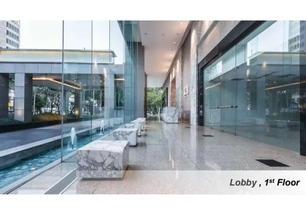Office Space for rent in Pathum Wan, Bangkok - Modern first-floor lobby with full-height glass walls, marble benches and a decorative water feature.