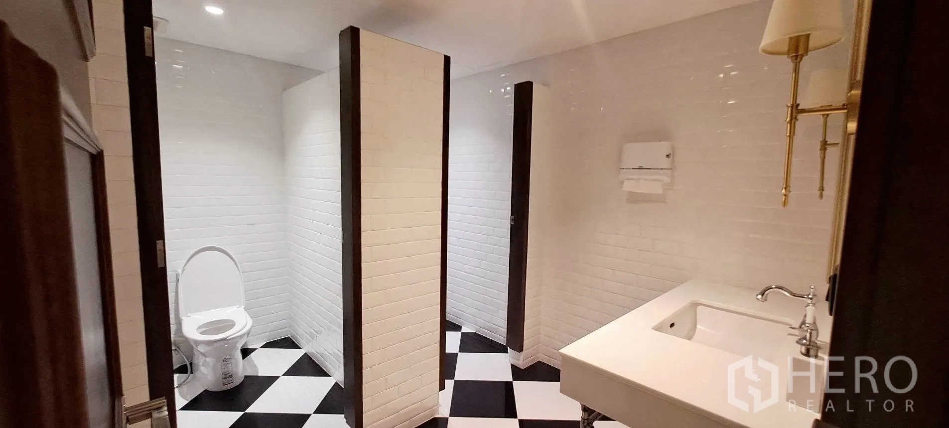 Home Office for rent in Lat Phrao, Bangkok - Multi-stall restroom with white subway tiles and checkerboard flooring.