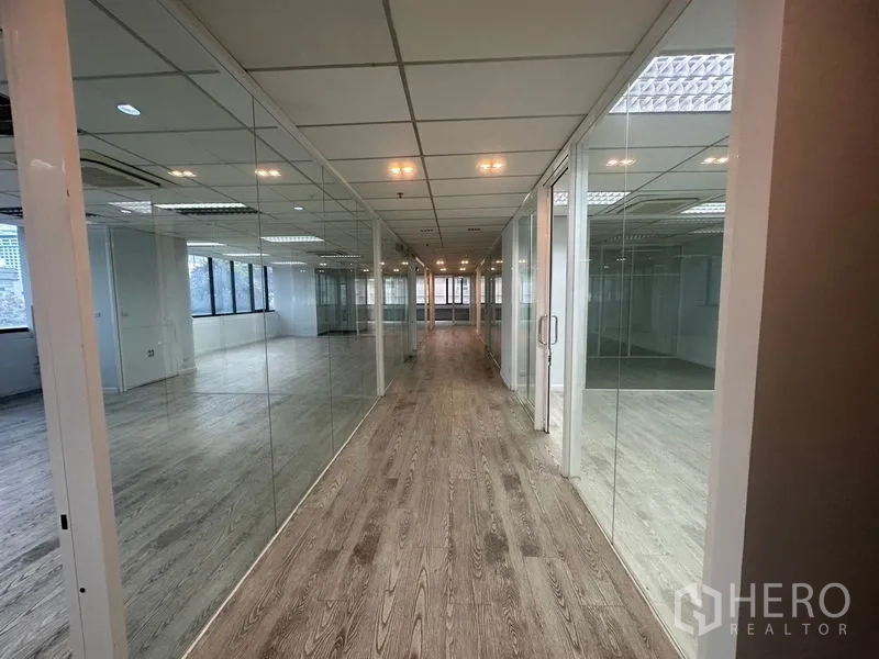 Office Space for rent in Din Daeng, Bangkok - Long corridor lined with glass offices and wood-look flooring.