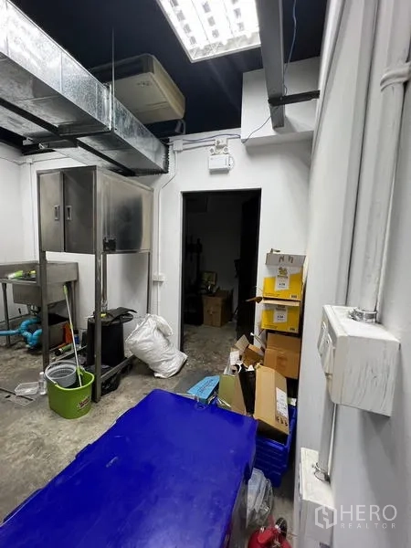 Retail Space for rent in Watthana, Bangkok - Service corridor and storage room with boxes and refrigeration unit.