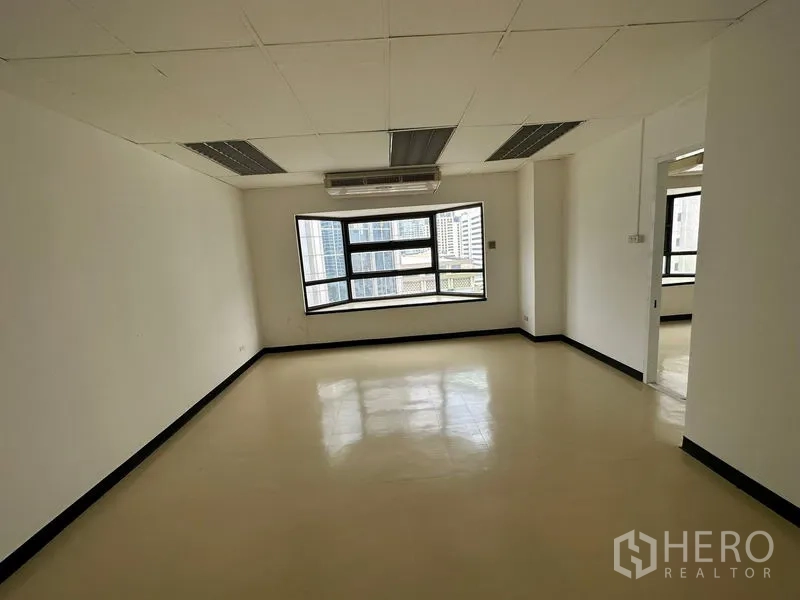 Office Space for rent in Pathum Wan, Bangkok - Private room or meeting area with a large window and ceiling AC overlooking city skyline.