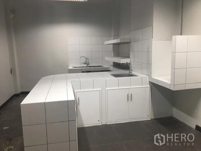Retail Space for rent in Watthana, Bangkok - Back-room pantry with white tiled counters, sink and storage cabinets.