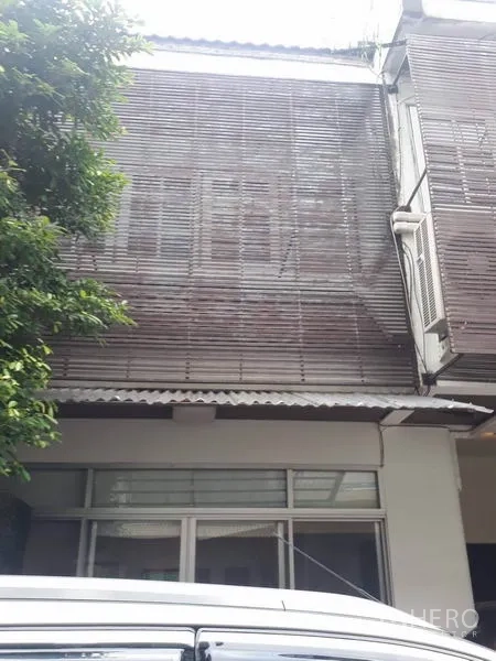Home Office for rent in Khlong Toei, Bangkok - Two-storey home office facade with wood slat sunshade and ground-floor windows.