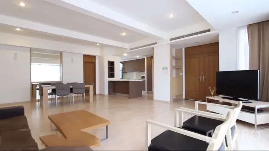 Condominium for rent in Watthana, Bangkok - Open-plan living and dining space with TV, sofa and wide windows.