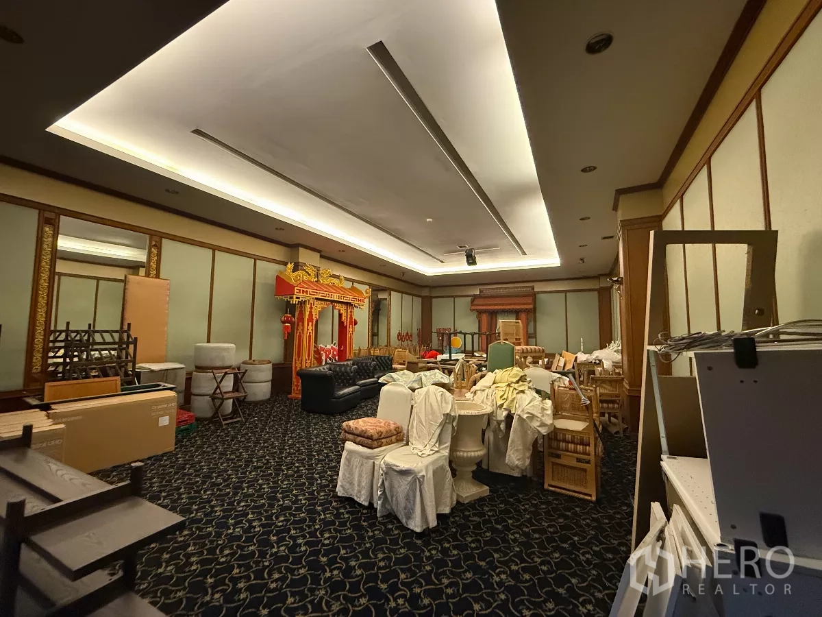 Retail Space for rent in Pathum Wan, Bangkok - Spacious hall with ceiling lights, decorative arch backdrop, sofas and stacked chairs.