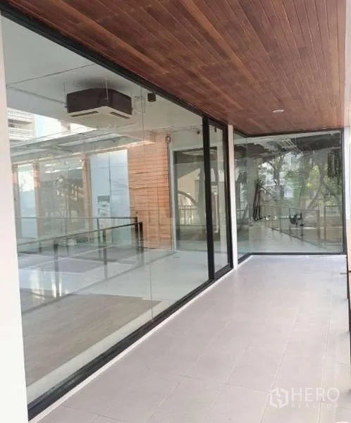 Retail Space for rent - Glass storefront beside a covered corridor with a wood ceiling.