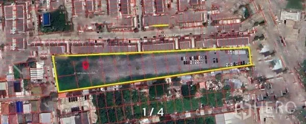 Land for rent in Prawet, Bangkok - Satellite view of a long rectangular land plot outlined in yellow along the Srinagarindra corridor, surrounded by urban housing.