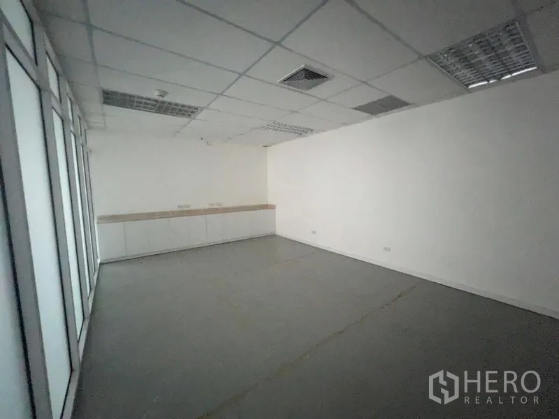 Office Space for rent - Enclosed meeting or pantry room with cabinets and glass partition wall.