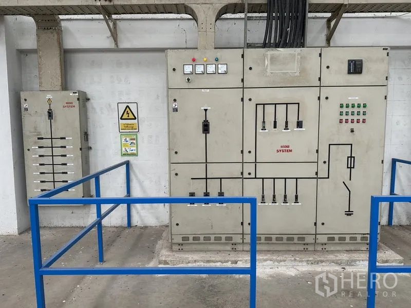 Factory for rent in Nonthaburi - Industrial three-phase electrical control panels with safety rails in the factory.
