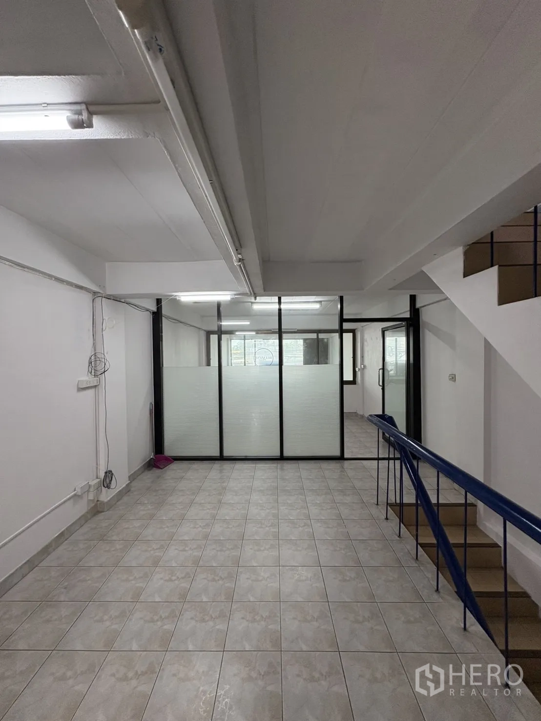 Shophouse for rent in Phra Khanong, Bangkok - Open area with frosted glass partitions creating office or meeting rooms.