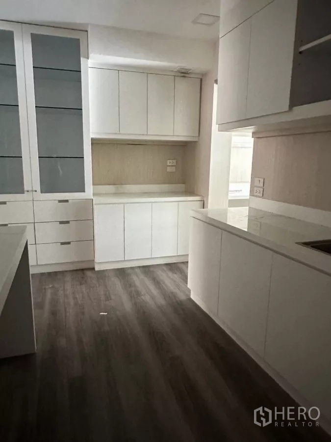 Shophouse for sale in Watthana, Bangkok - Floor with white built-in cabinetry and pantry-style workspace.