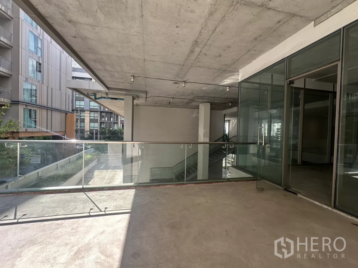 Retail Space for rent - External shopfront and terrace beside the escalator with modern glass railings.