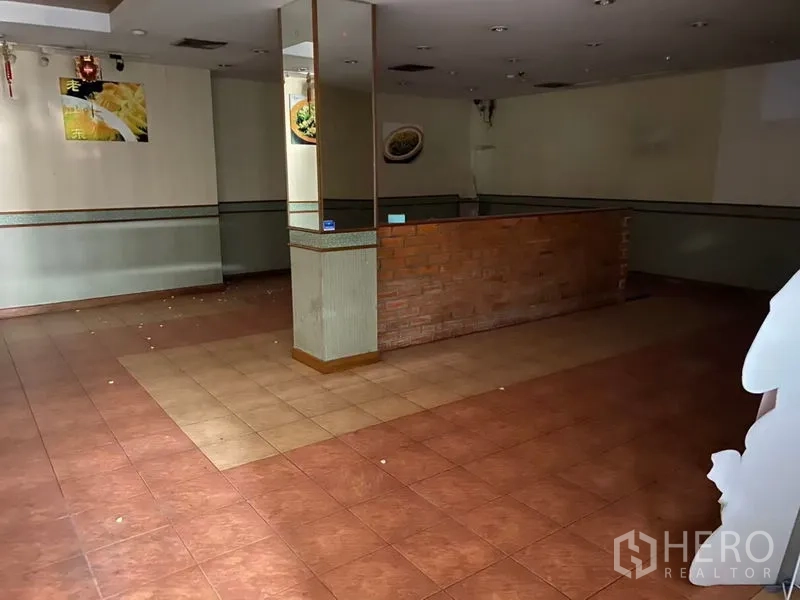 Retail Space for rent in Bang Rak, Bangkok - Empty retail unit with tiled floors, a brick service counter, and recessed lighting in Silom, Bangkok.