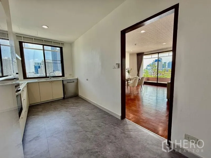 Condominium for rent - Kitchen doorway opening to the living area with balcony beyond.