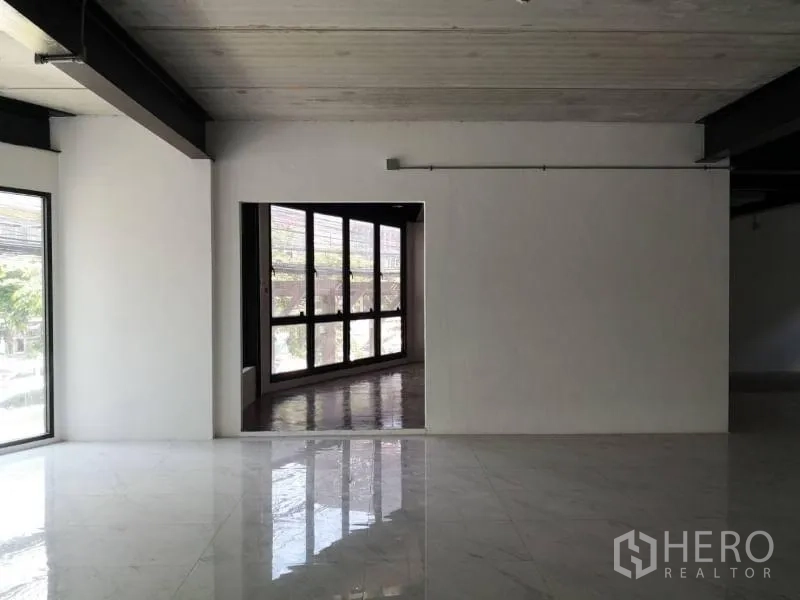 Office Space for rent in Chatuchak, Bangkok - Partition wall with doorway leading to a glass‑lined corridor and wide exterior windows.
