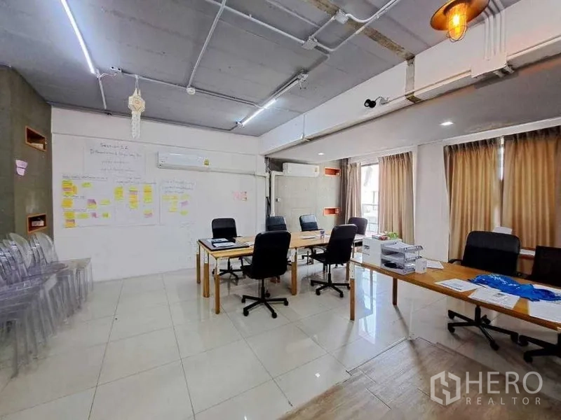 Retail Space for rent in Khlong Toei, Bangkok - Spacious upper-floor office and meeting area with work tables, AC units and natural light.