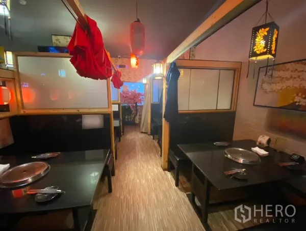 Retail Space for rent in Watthana, Bangkok - Booth seating with built-in grill plates and warm ambient lighting
