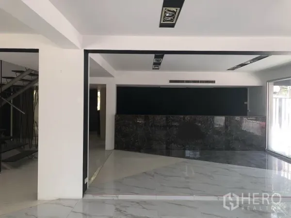 Retail Space for rent in Watthana, Bangkok - Spacious showroom area with marble counter, recessed ceiling lights and large display windows.