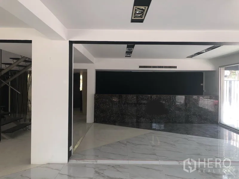 Retail Space for rent in Watthana, Bangkok - Spacious showroom area with marble counter, recessed ceiling lights and large display windows.