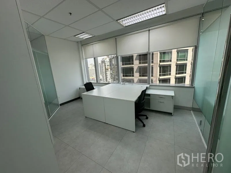 Office Space for rent - Bright corner office with white desks, large windows and skyline outlook.