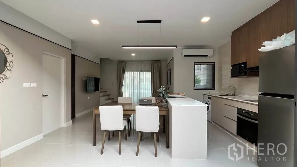 Townhouse for rent or sale in Bang Phli, Samut Prakan - Linear kitchen with sink, oven, cooktop and front‑loading washer.