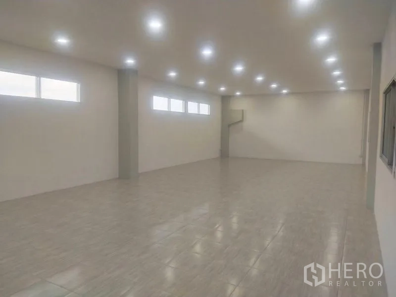 Factory for sale in Bang Sao Thong, Samut Prakan - Multi-purpose room with tiled floor, high strip windows and ceiling lights.
