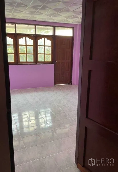 货栈 出租在Sai Noi, Nonthaburi - 第二办公房，紫色墙面、大窗户、瓷砖地面与木门。