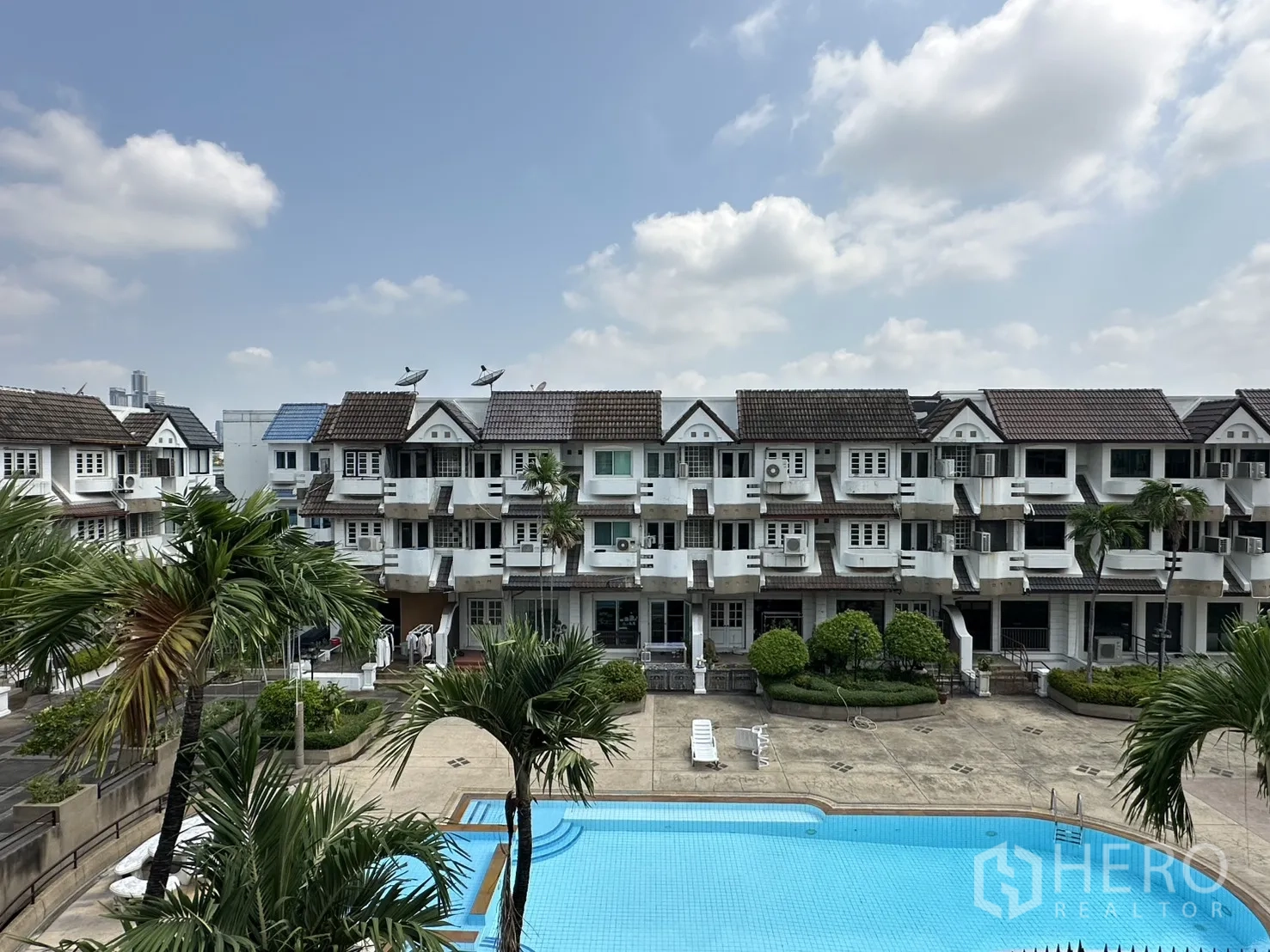 Home Office for rent in Watthana, Bangkok - View of a communal swimming pool and surrounding townhouse buildings.