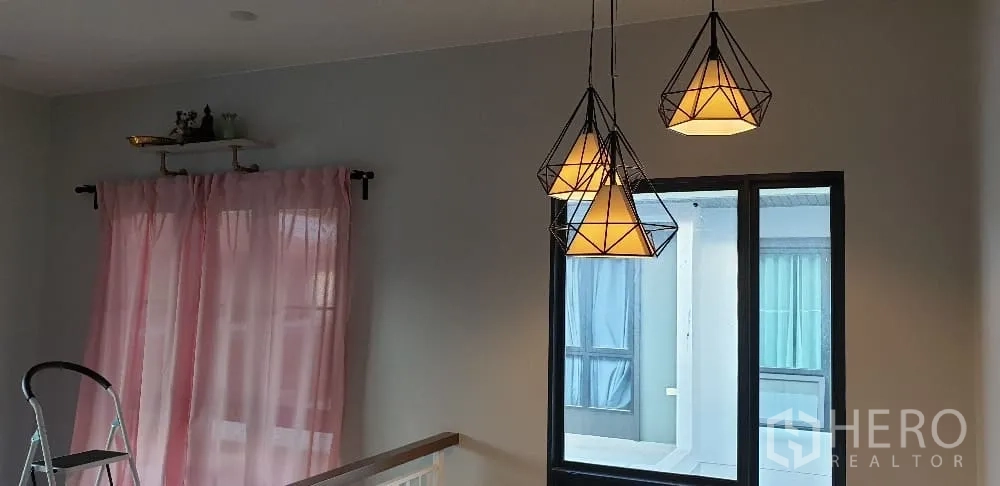 Detached House for rent or sale in Lam Luk Ka, Pathum Thani - Geometric pendant lights above the stair landing near window.