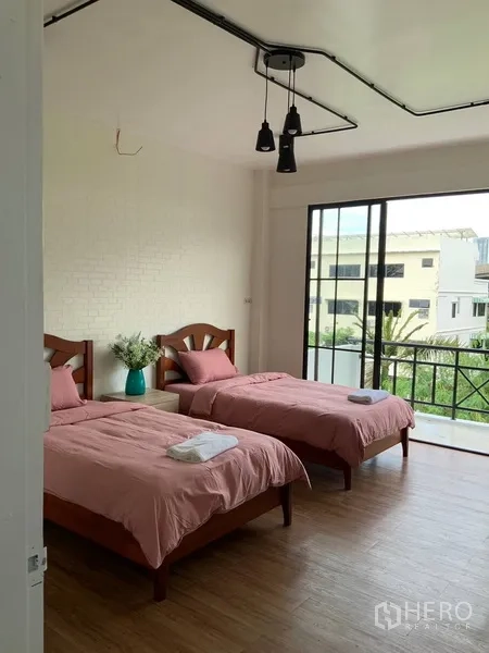 Home Office for rent or sale in Phra Khanong, Bangkok - Bright bedroom with twin beds and sliding doors opening to a balcony.