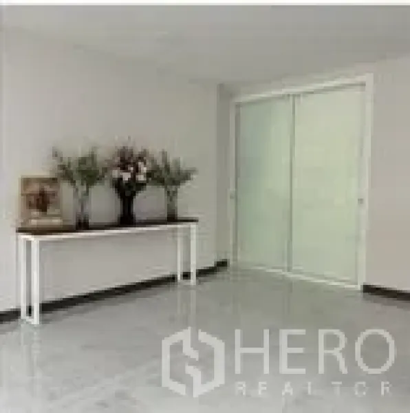 Home Office for rent in Wang Thonglang, Bangkok - Bright lobby space with white walls, marble-look floor and frosted sliding glass doors.