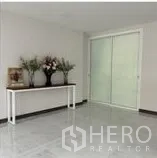 Home Office for rent in Wang Thonglang, Bangkok - Bright lobby space with white walls, marble-look floor and frosted sliding glass doors.