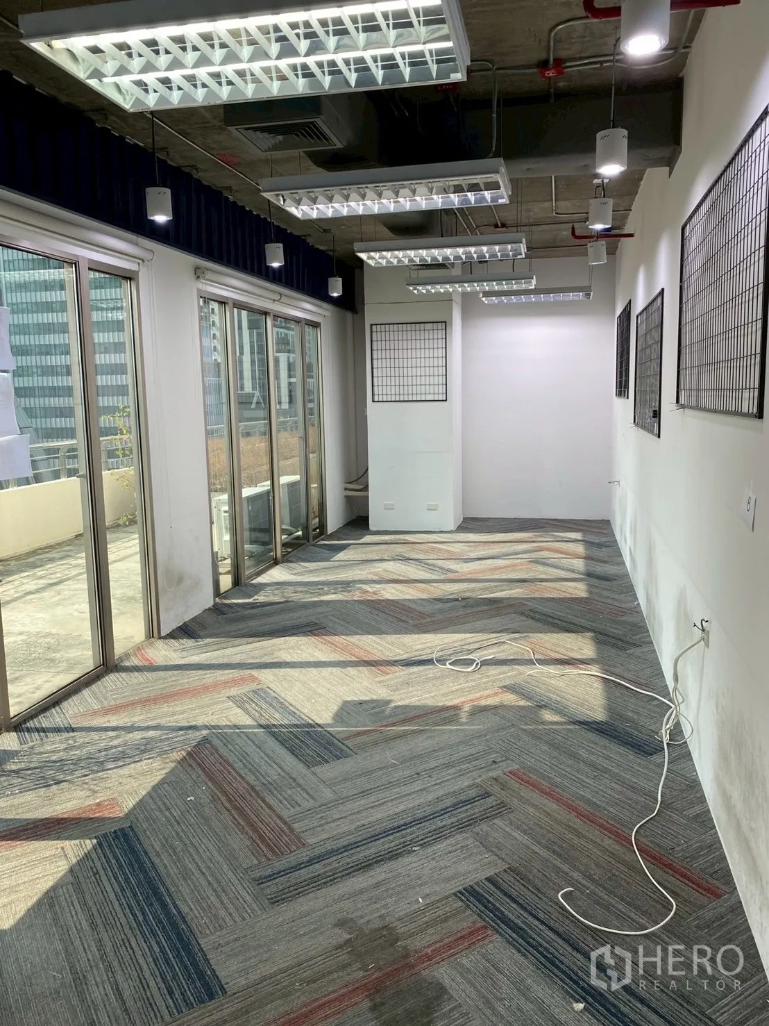 Office Space for rent in Watthana, Bangkok - Long room with sliding glass doors opening to an outdoor terrace area.