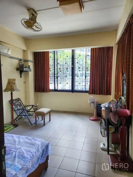 Shophouse for rent in Bang Rak, Bangkok - Upper-floor room with large barred windows, curtains and tiled floor.