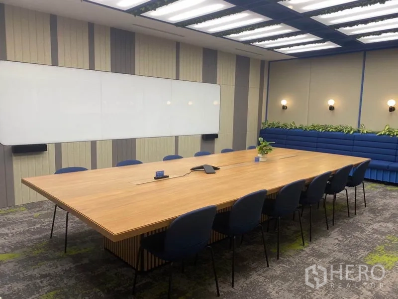 Office Space for rent in Pathum Wan, Bangkok - Boardroom view with built-in bench seating, greenery accents and large meeting table.